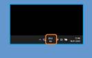 Der Infobereich eines Windows 11 (hier im Dark Mode) mit aktivem Sprachumschalter-Symbol